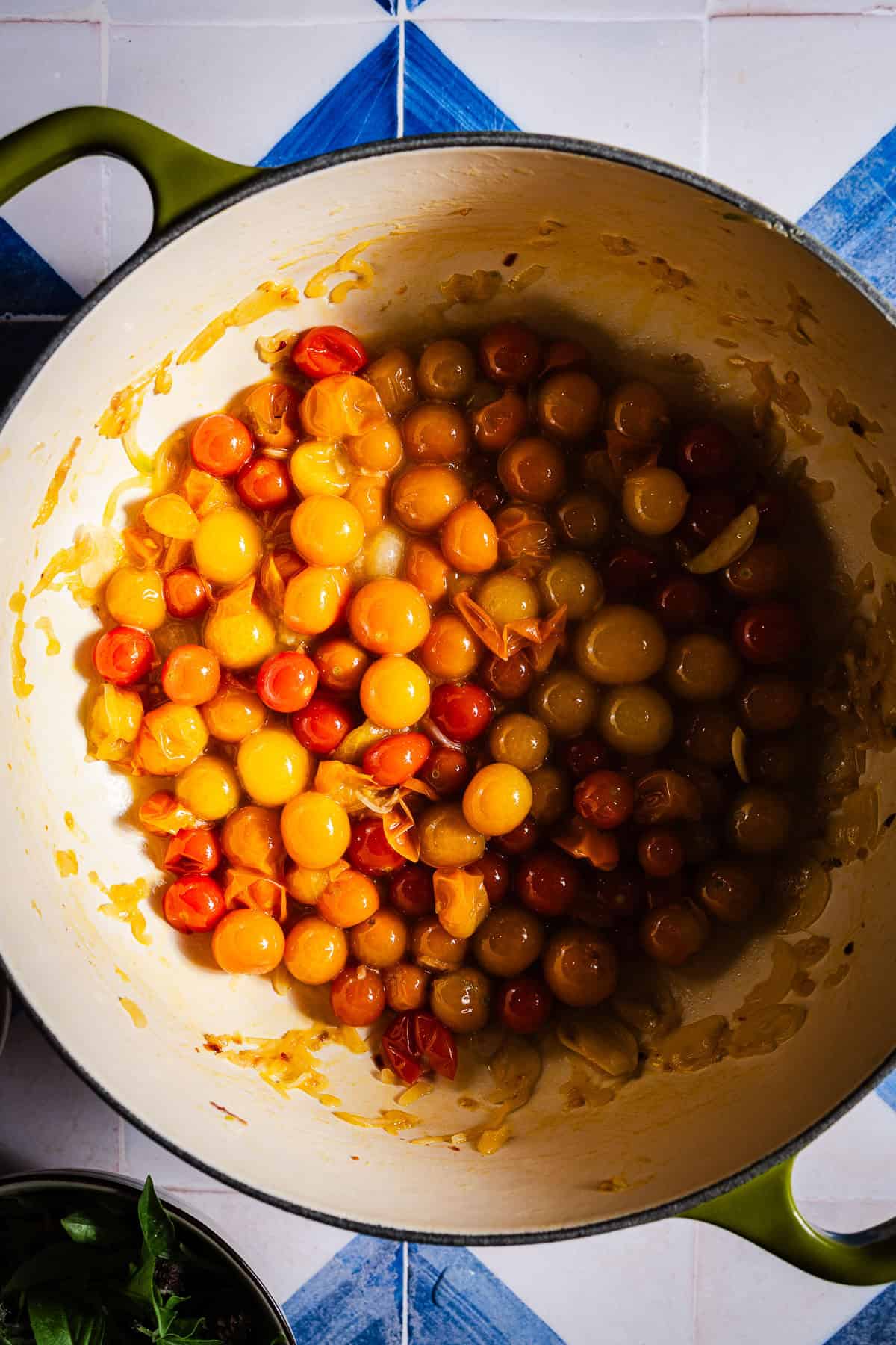 Blistering cherry tomatoes in a dutch oven.