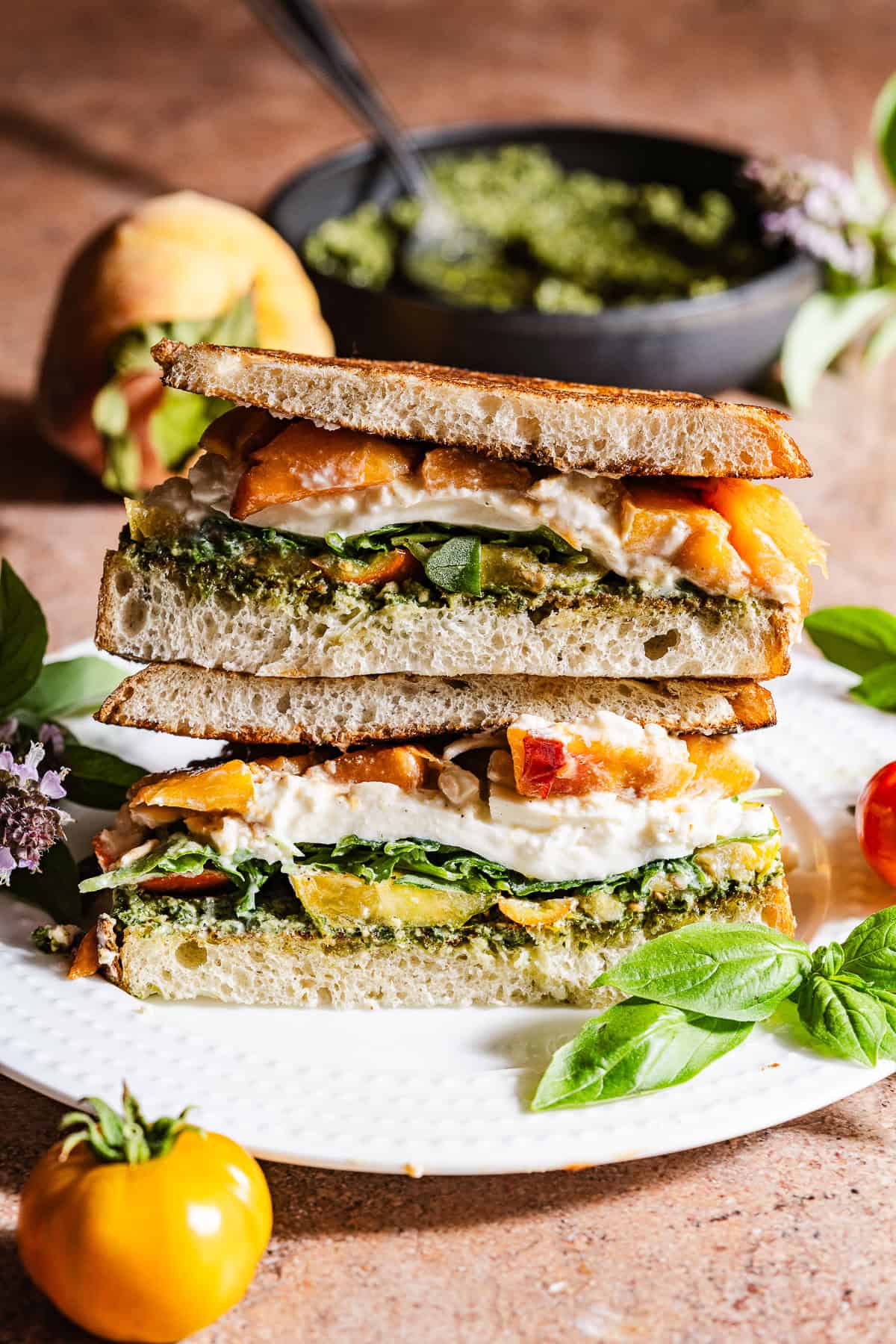 A grilled sandwich with peaches, burrata, and pesto.