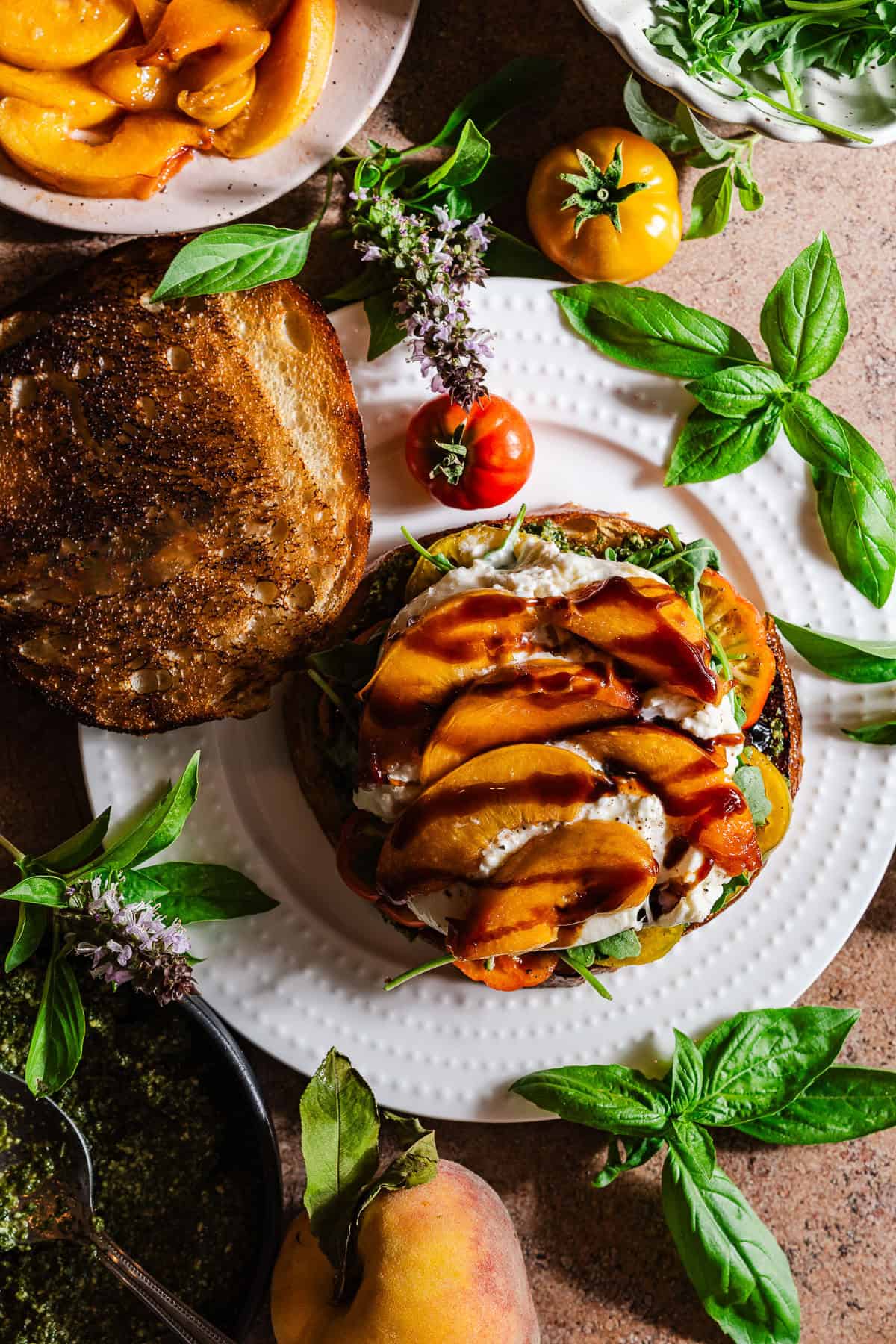 A grilled sandwich with peaches, burrata, and pesto.