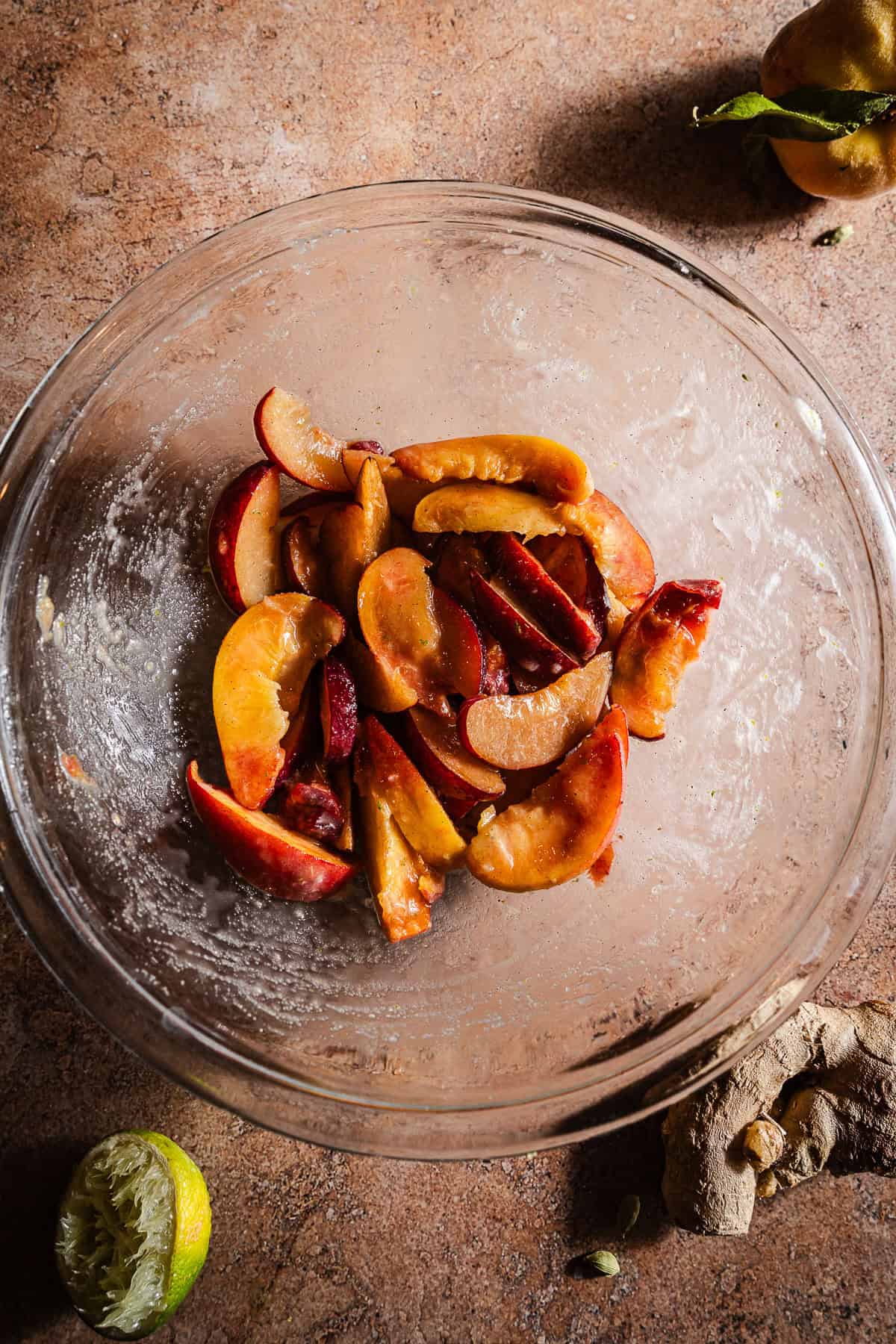 Sliced peaches and plums mixed with the sugar corn starch mixture