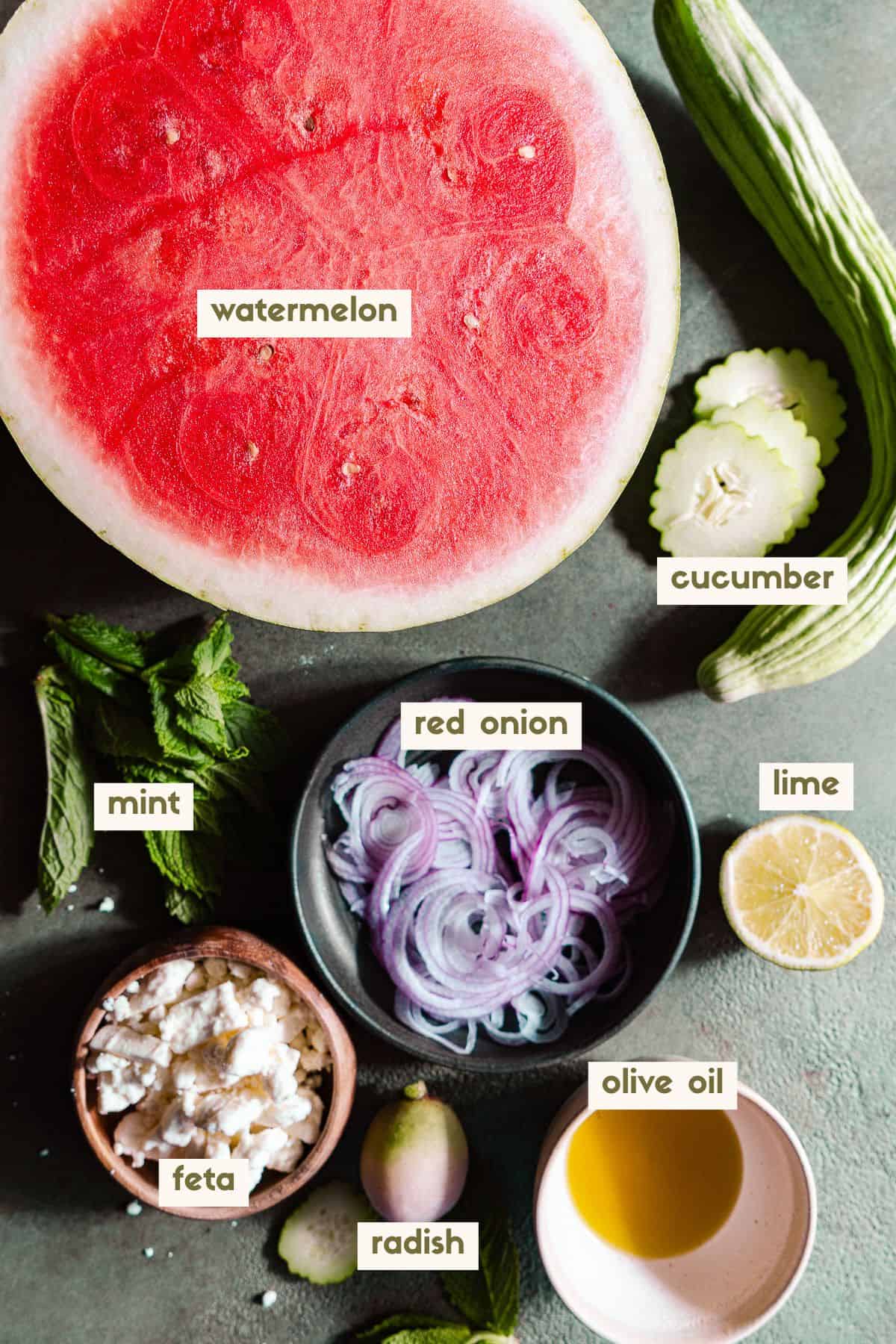 Watermelon, cucumber, red onion, lime, mint, feta, radish, olive oil ingredients with labels.