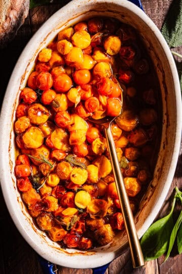Tomato Confit in a baking dish with a being spooned.
