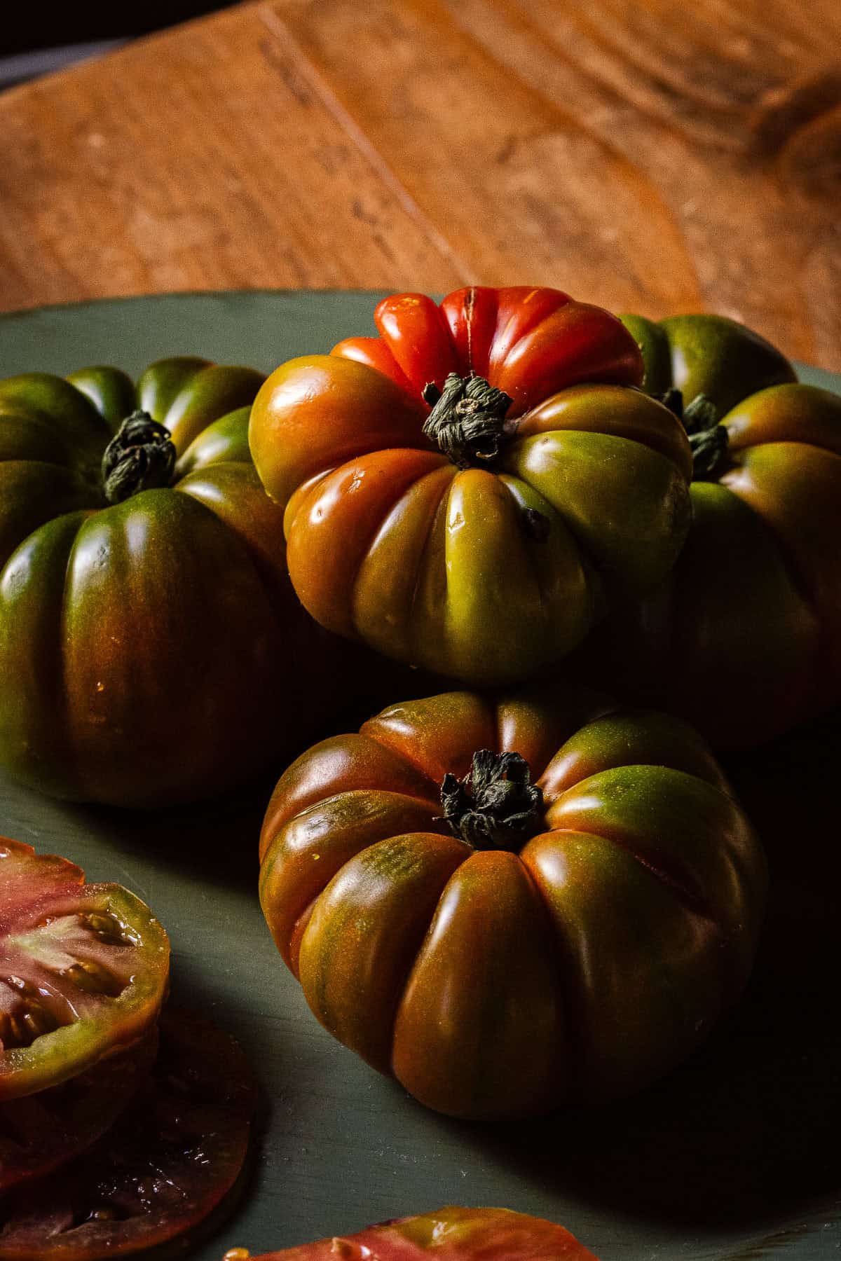 A plate of green and red heirloom tomatoes.