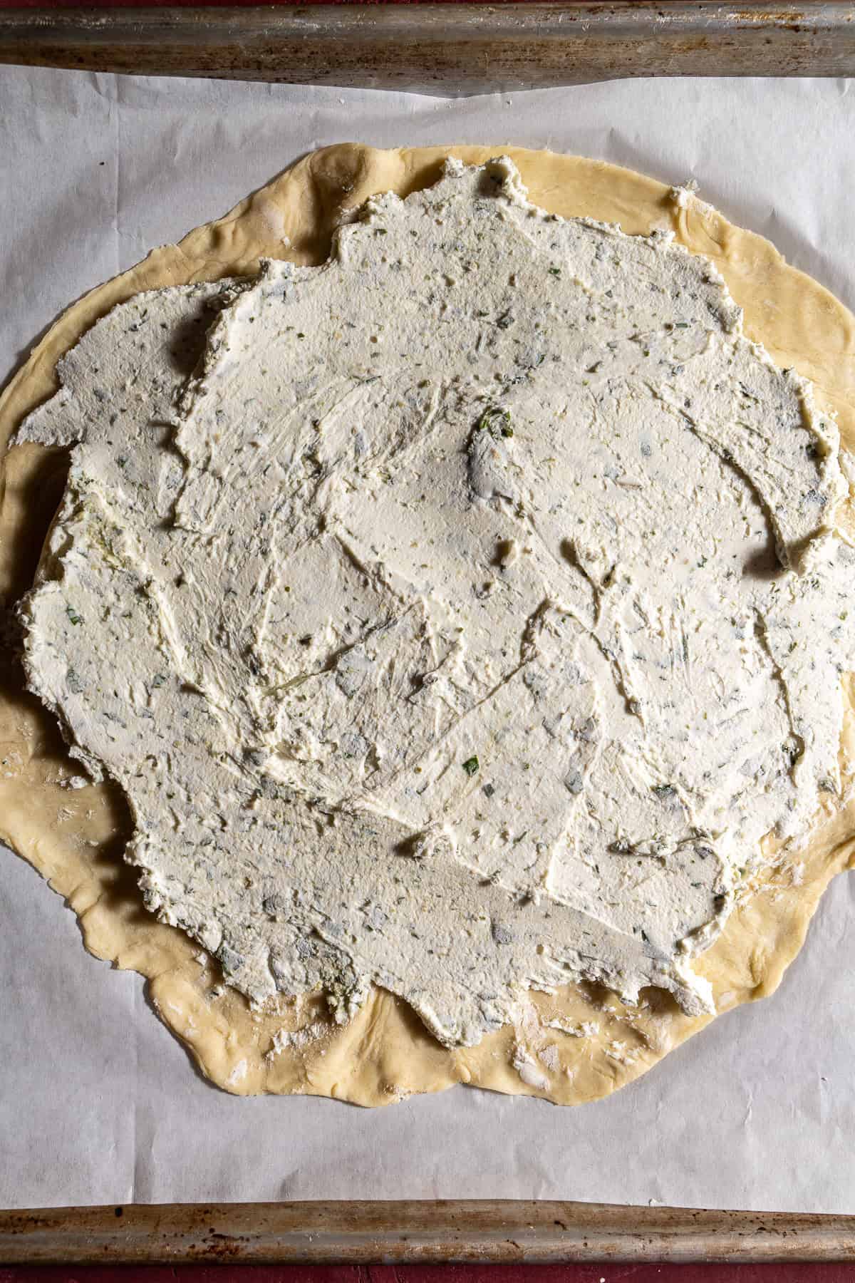 Dough topped with herbed goat cheese.