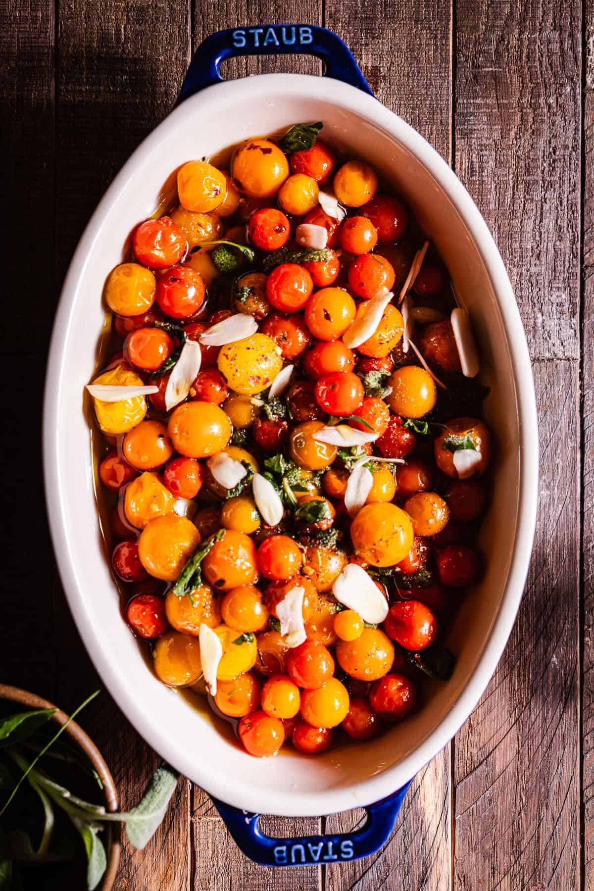 Ingredients for tomato confit in a baking dish before it's slow roasted.